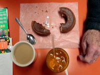 A customer enjoys his breakfast and his morning medication at Ma's Donuts on Acushnet Avenue in the north end of New Bedford.   PETER PEREIRA/THE STANDARD-TIMES/SCMG